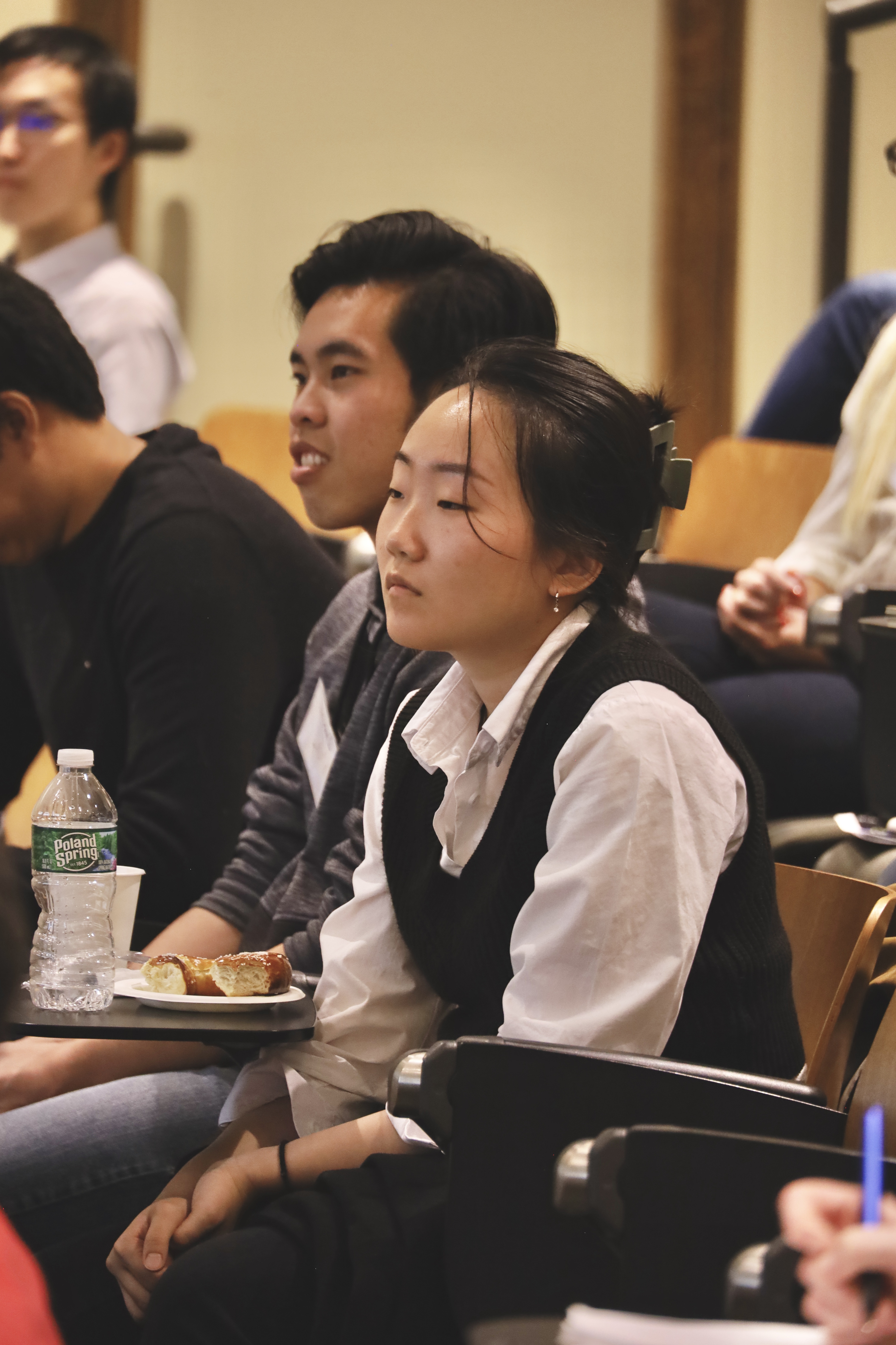 People in audience in lecture hall seats