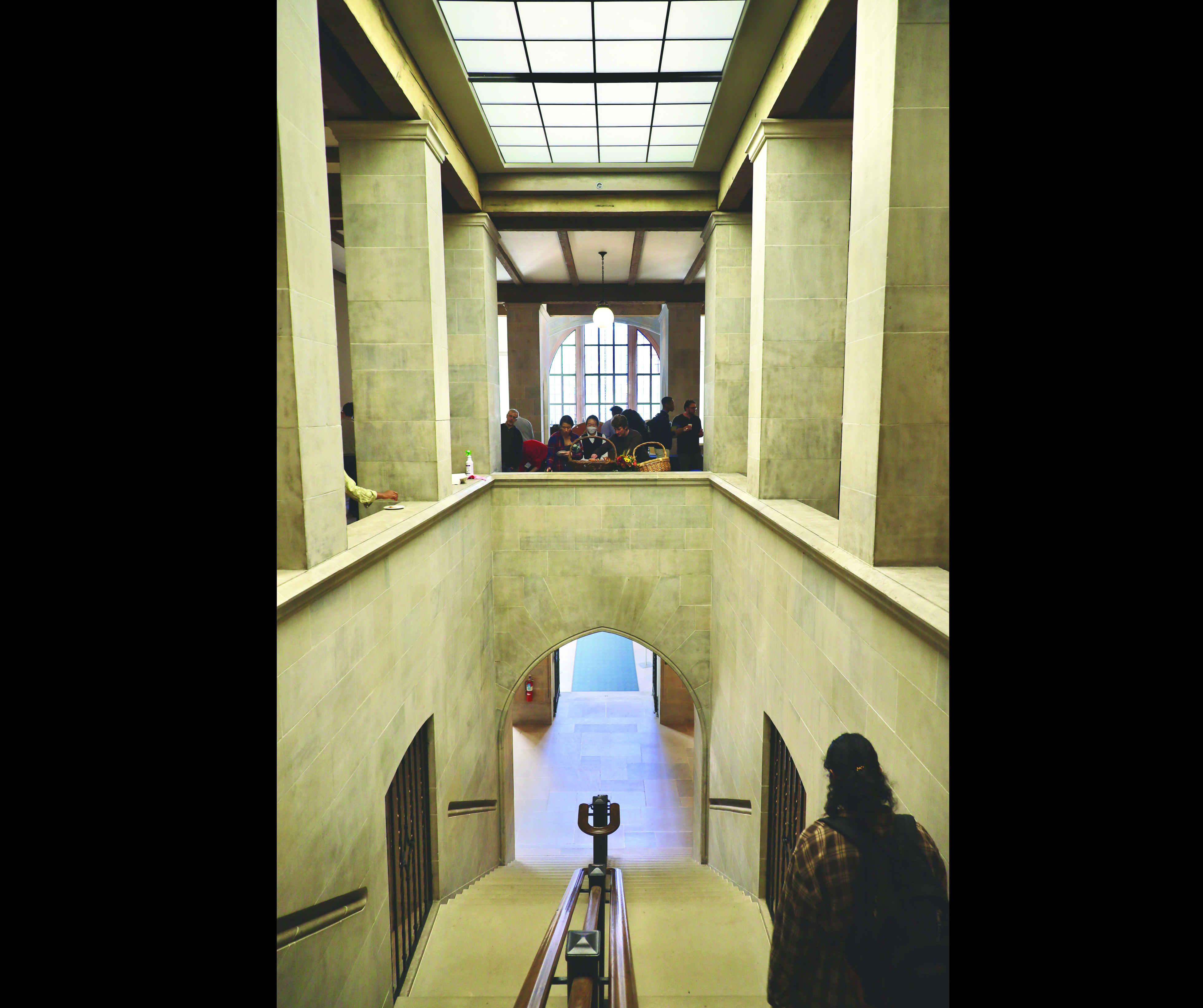 woman walking down concrete staircase people in background