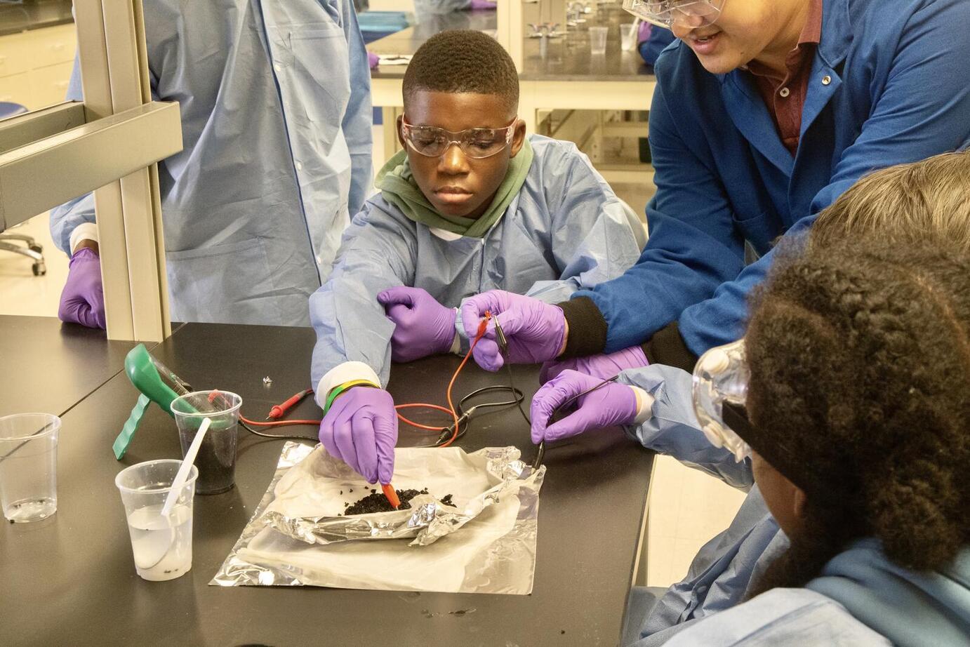 boy performing experiment on lab bench