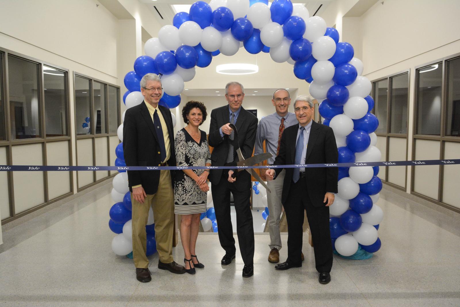 people cutting giant ribbon