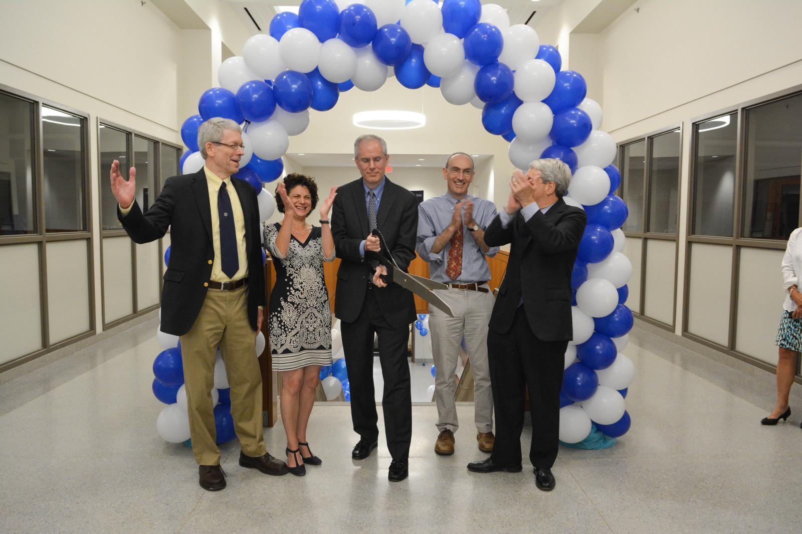 people cutting giant ribbon