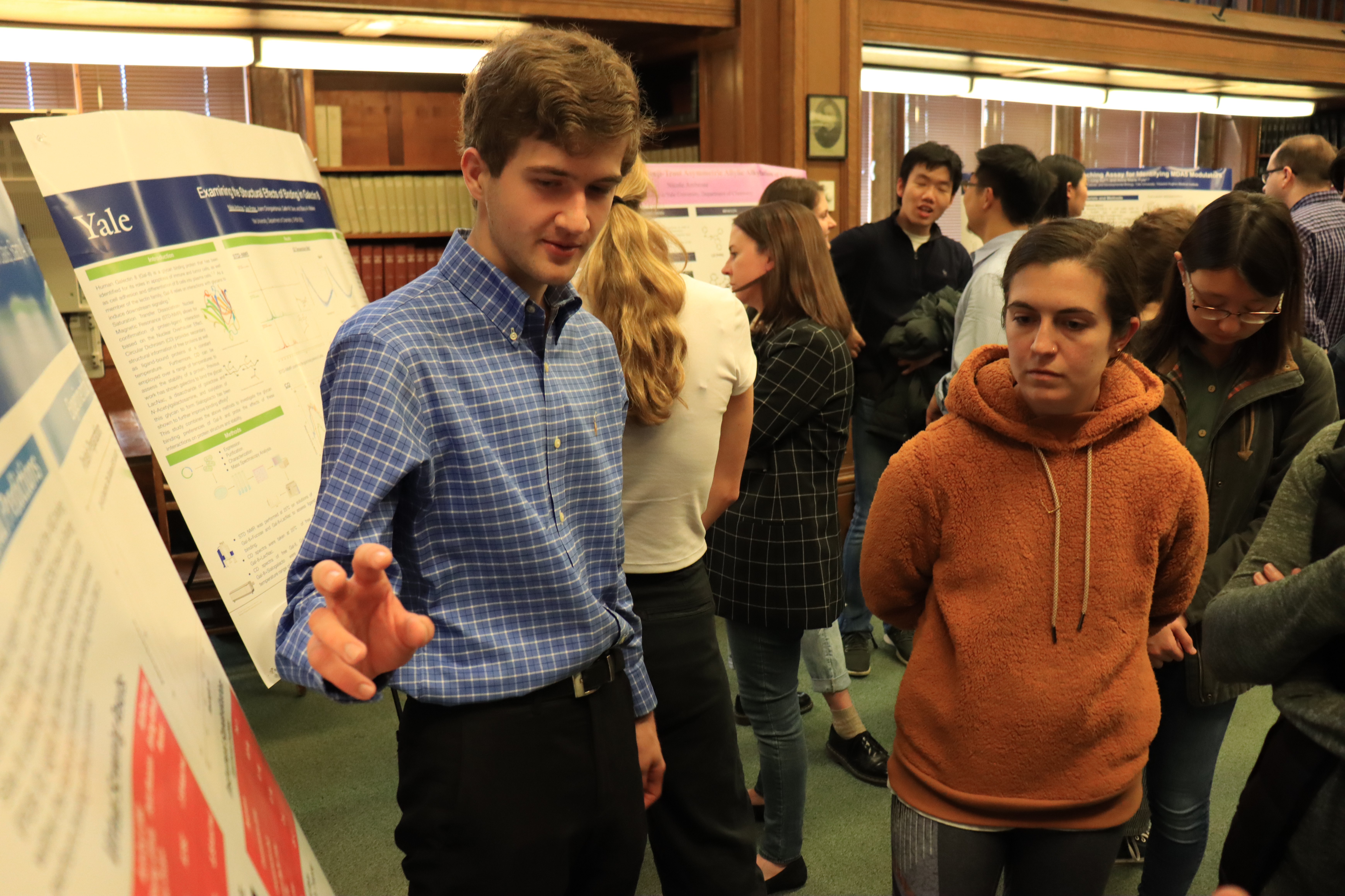 man pointing at poster