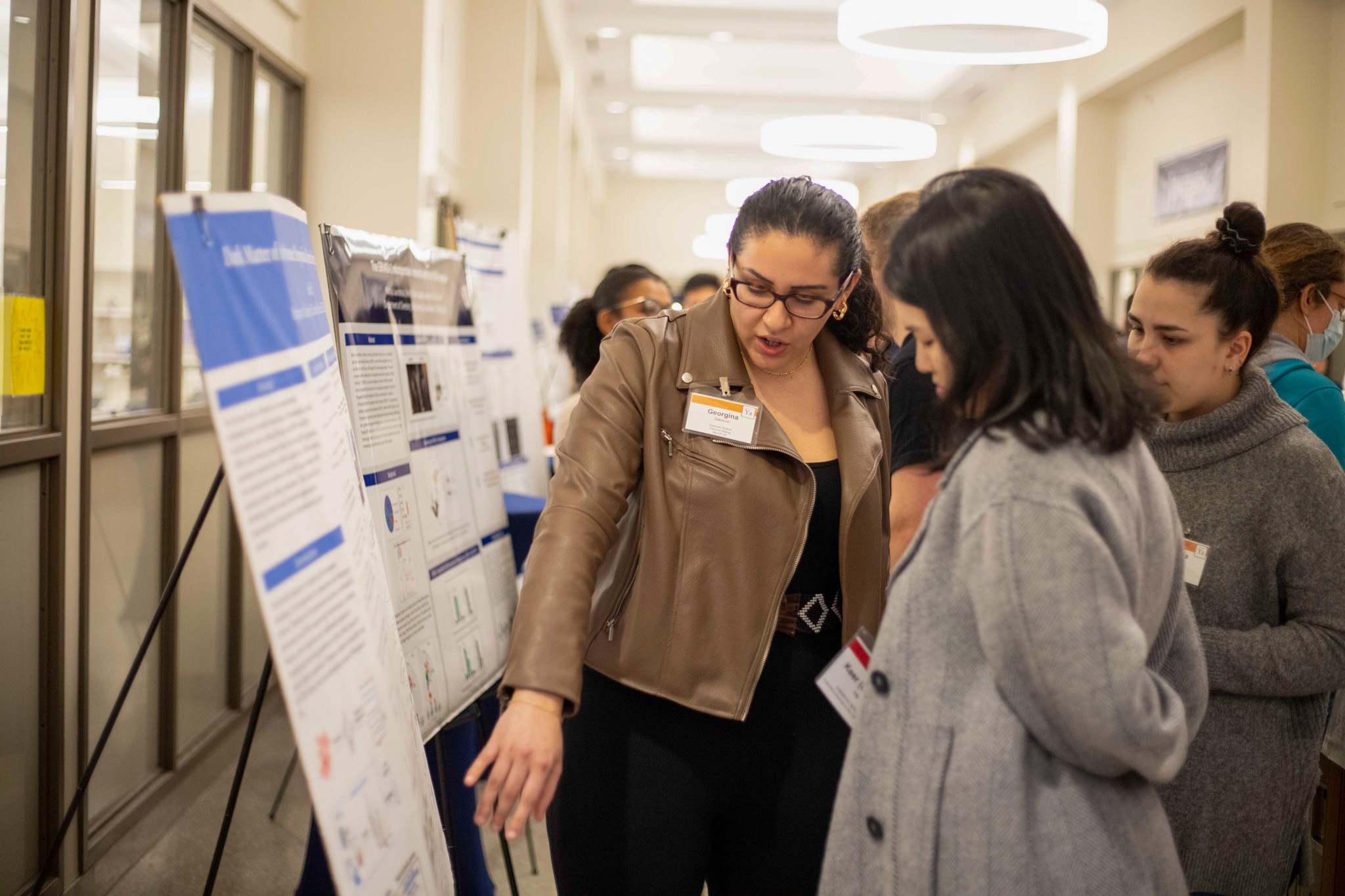 women pointing at poster