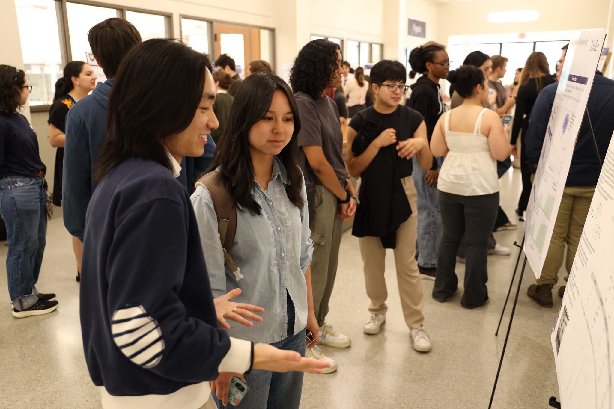 students discussing poster research