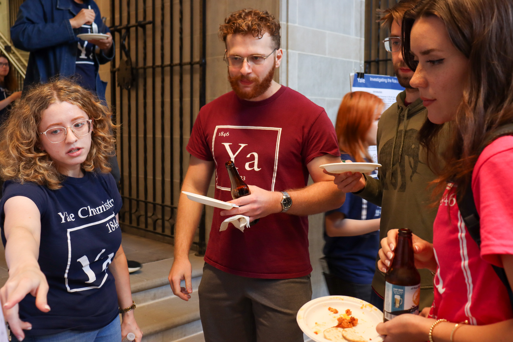 student presenting poster to students