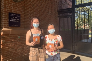 two women holding flyers