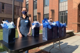 woman standing at table with gift bags