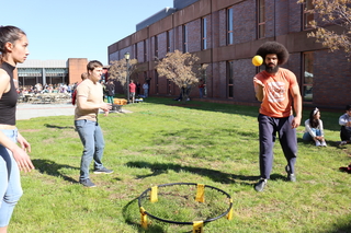 people playing spike ball on grass