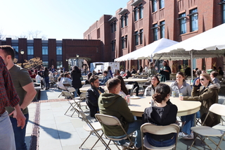 people eating at round tables