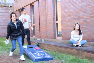 man and woman playing cornhole