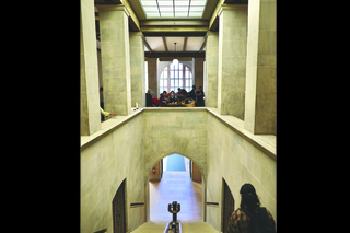 woman walking down concrete staircase people in background