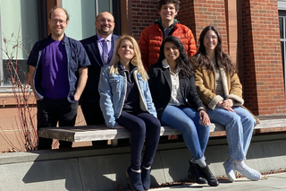 group of people sitting on bench