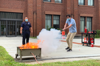 man putting out fire extinguisher