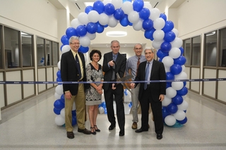 people cutting giant ribbon