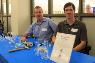 Men sitting at table with glassware