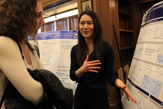 woman pointing at poster