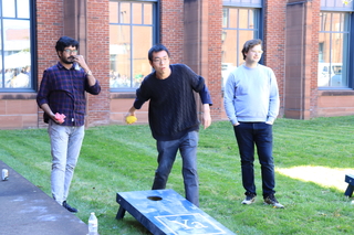 people paying corn hole game