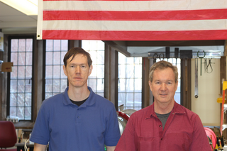 two men standing in shop