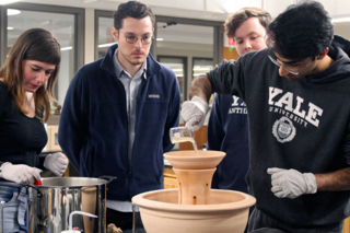 students standing around a vat of liquid