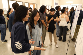 students discussing poster research