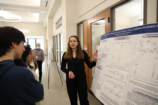 woman presenting poster