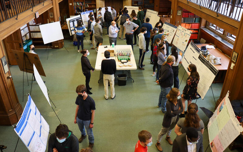 aerial view of people and poster in large room