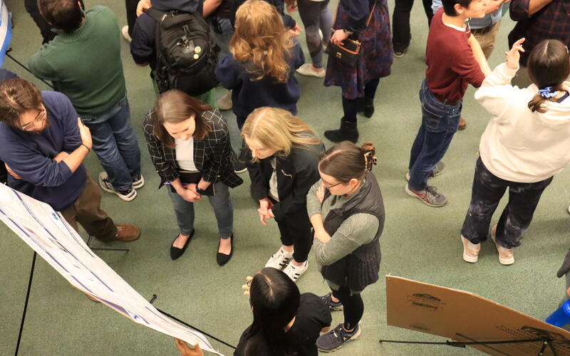 aerial view of people talking near poster