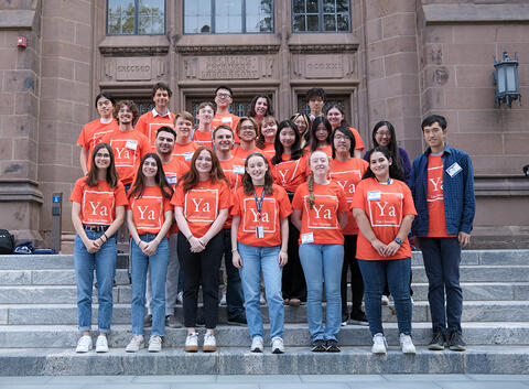 group of students standing on steps of building