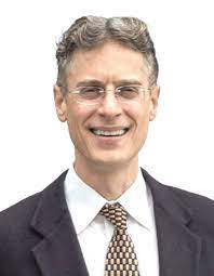 Portrait of a man wearing suit, tie, glasses