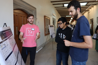 men talking near poster