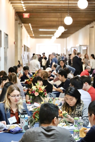 people eating at tables in hallway