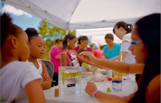 kids experimenting at table