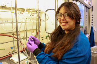 woman with marker in hand by fume hood