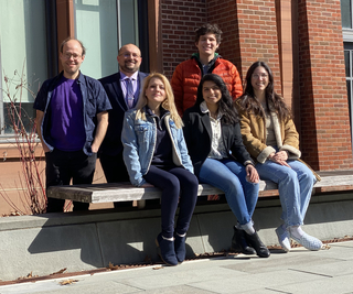 group of people sitting on bench