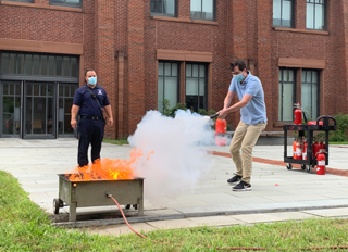 man putting out fire extinguisher