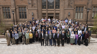 group of people outside brick building