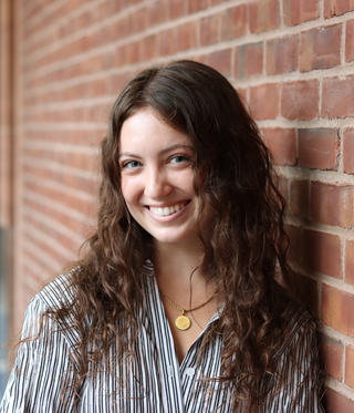 person leaning on brick wall