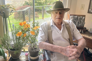 guy sitting near flowers