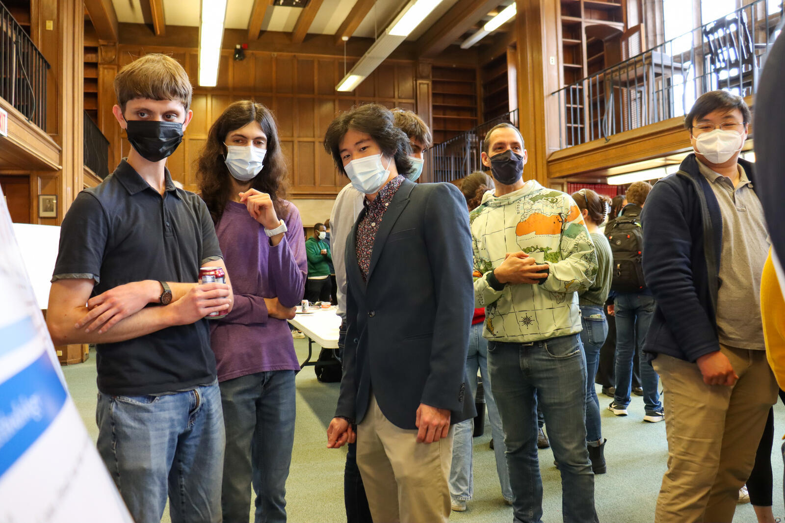 people looking at poster in library