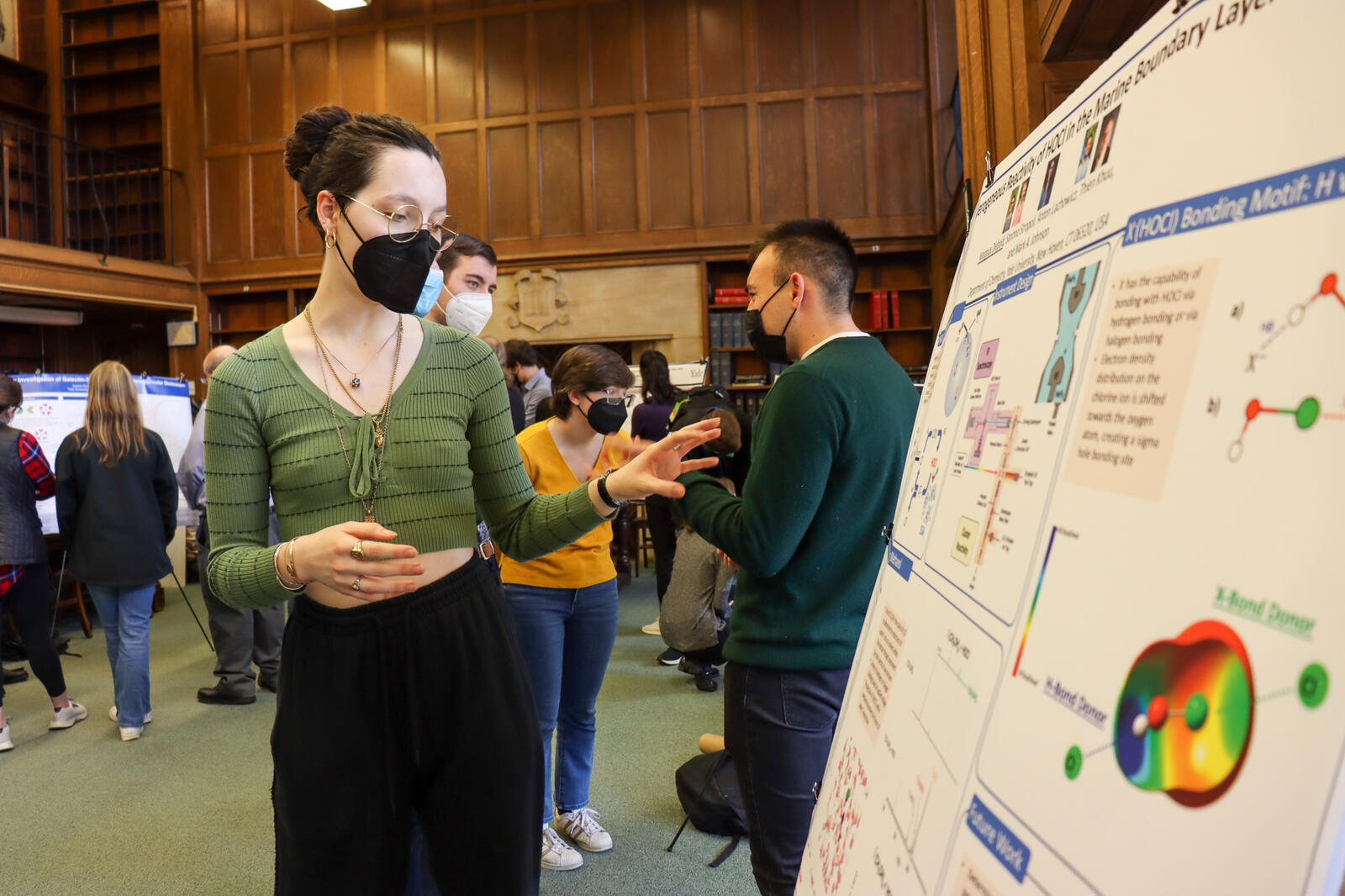 Woman pointing to poster in library