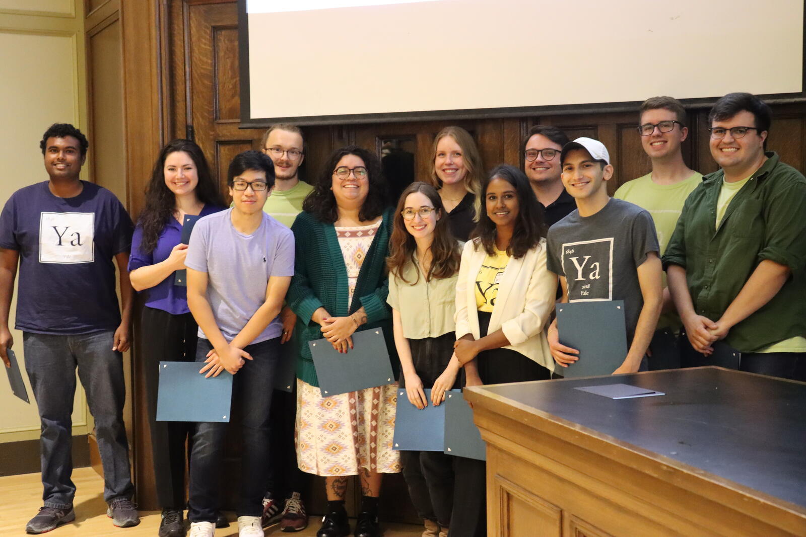 people standing holding certificates