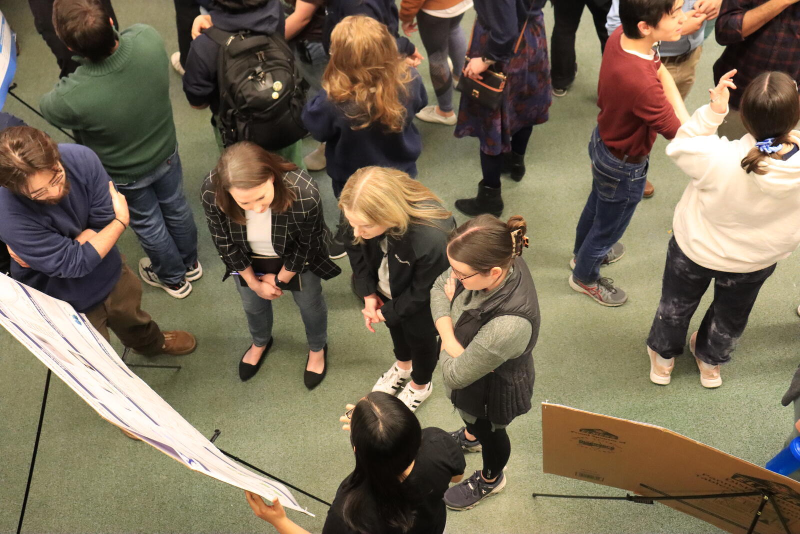 aerial view of people talking near poster