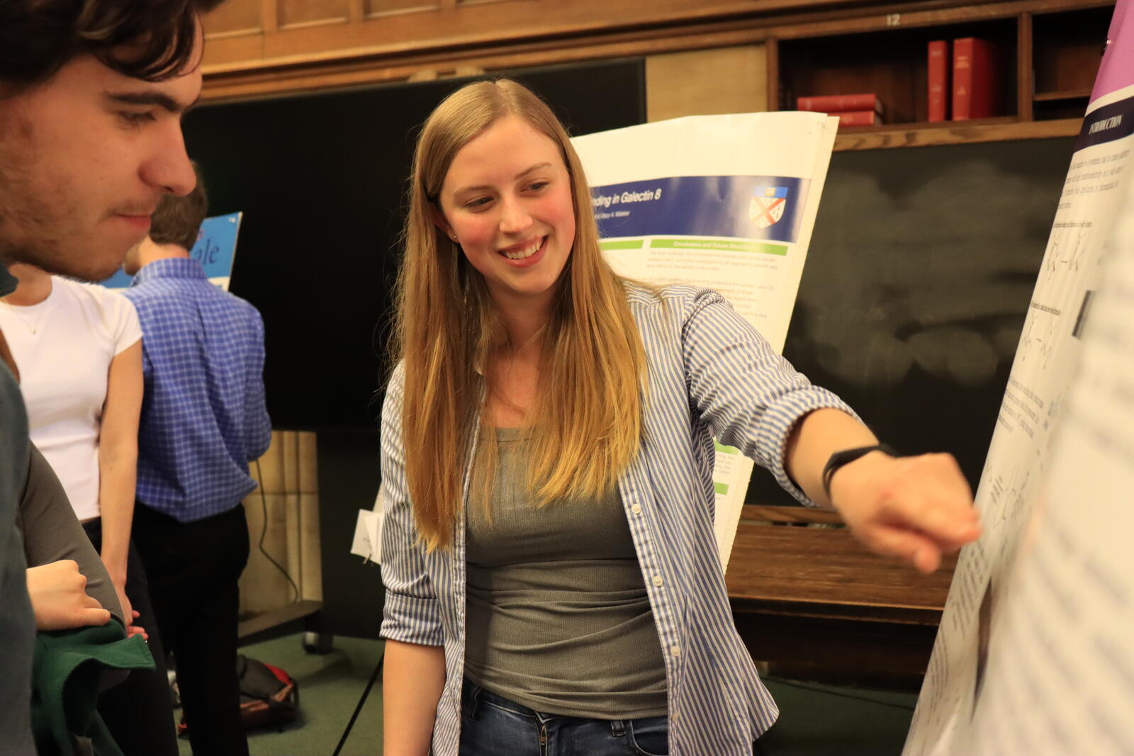 woman pointing at poster