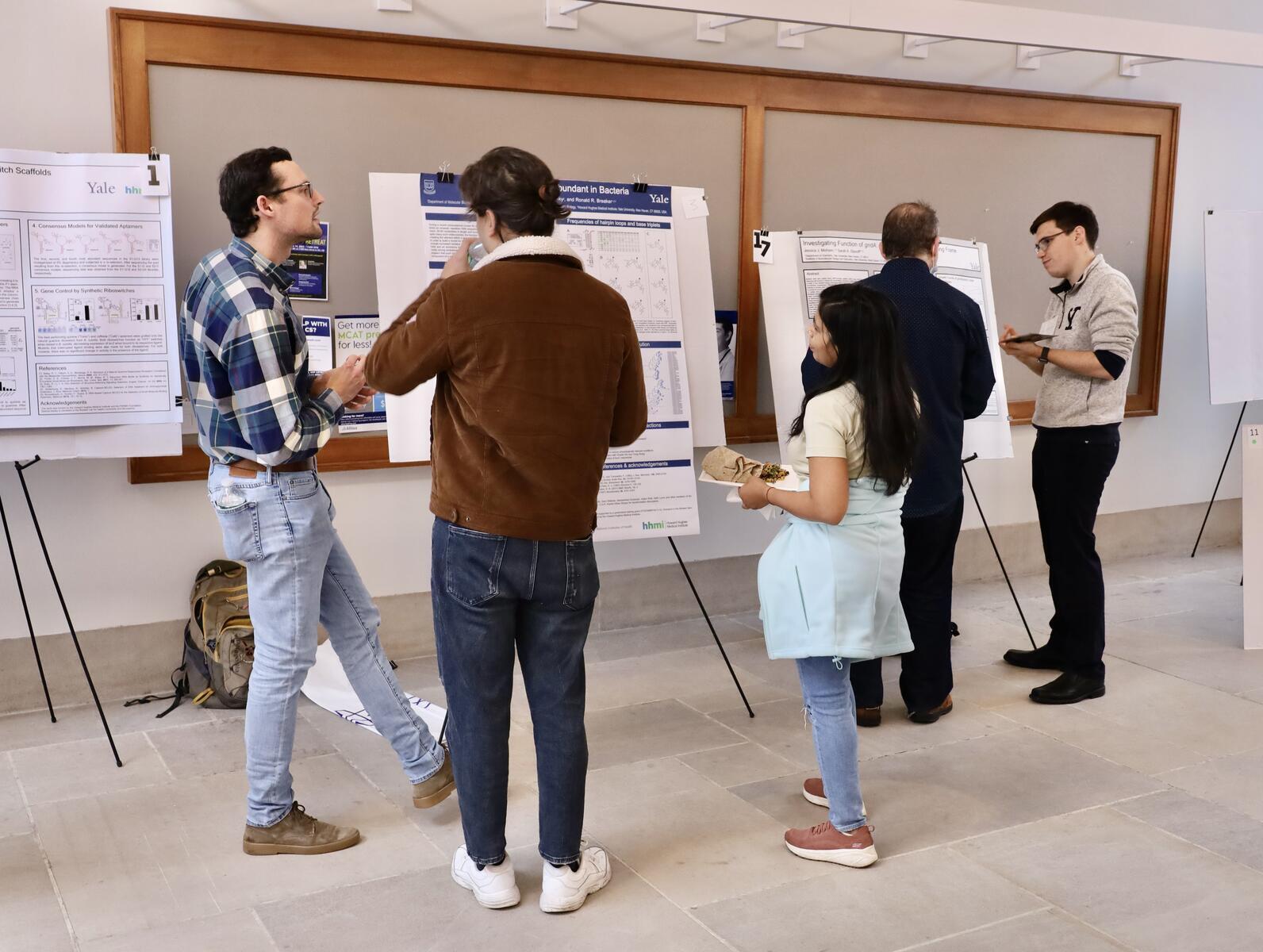 People chatting near research posters