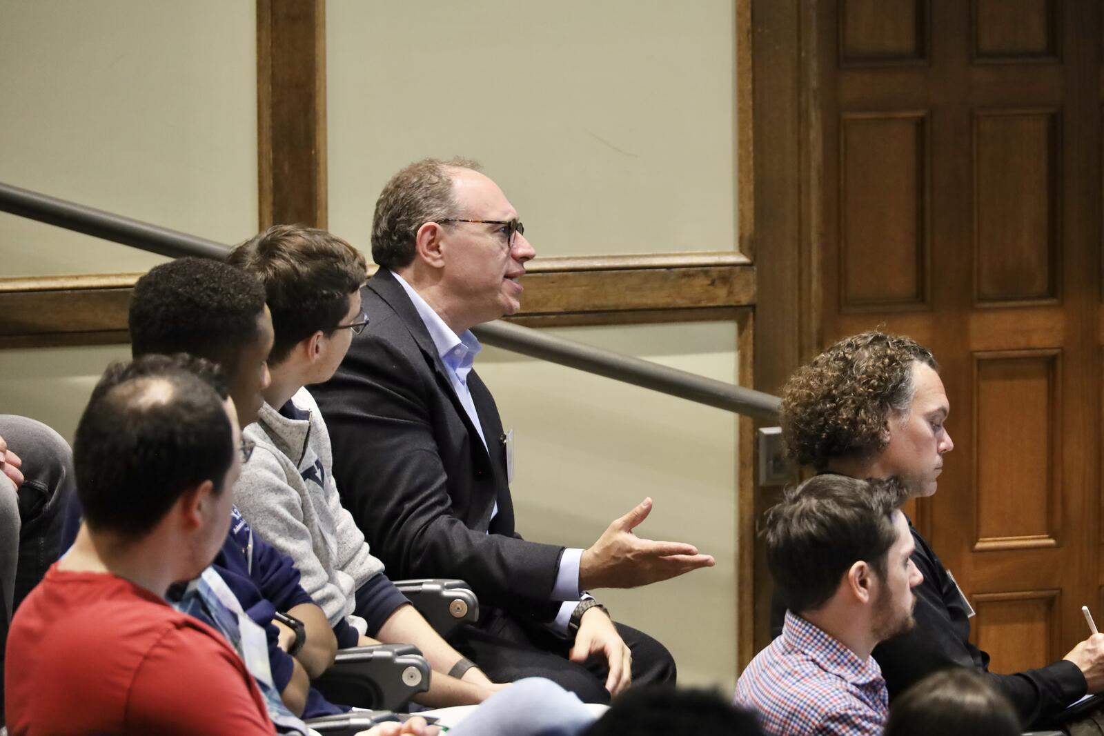 Man in audience talking and gesturing