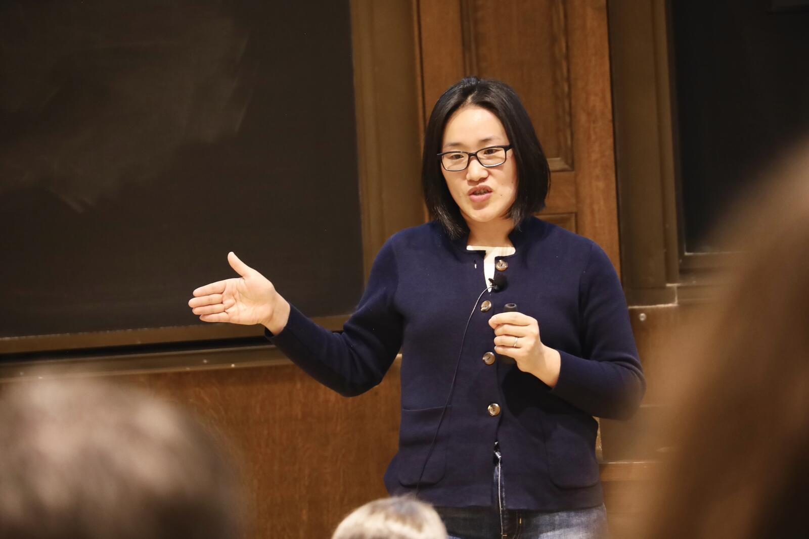 Woman speaking holding microphone