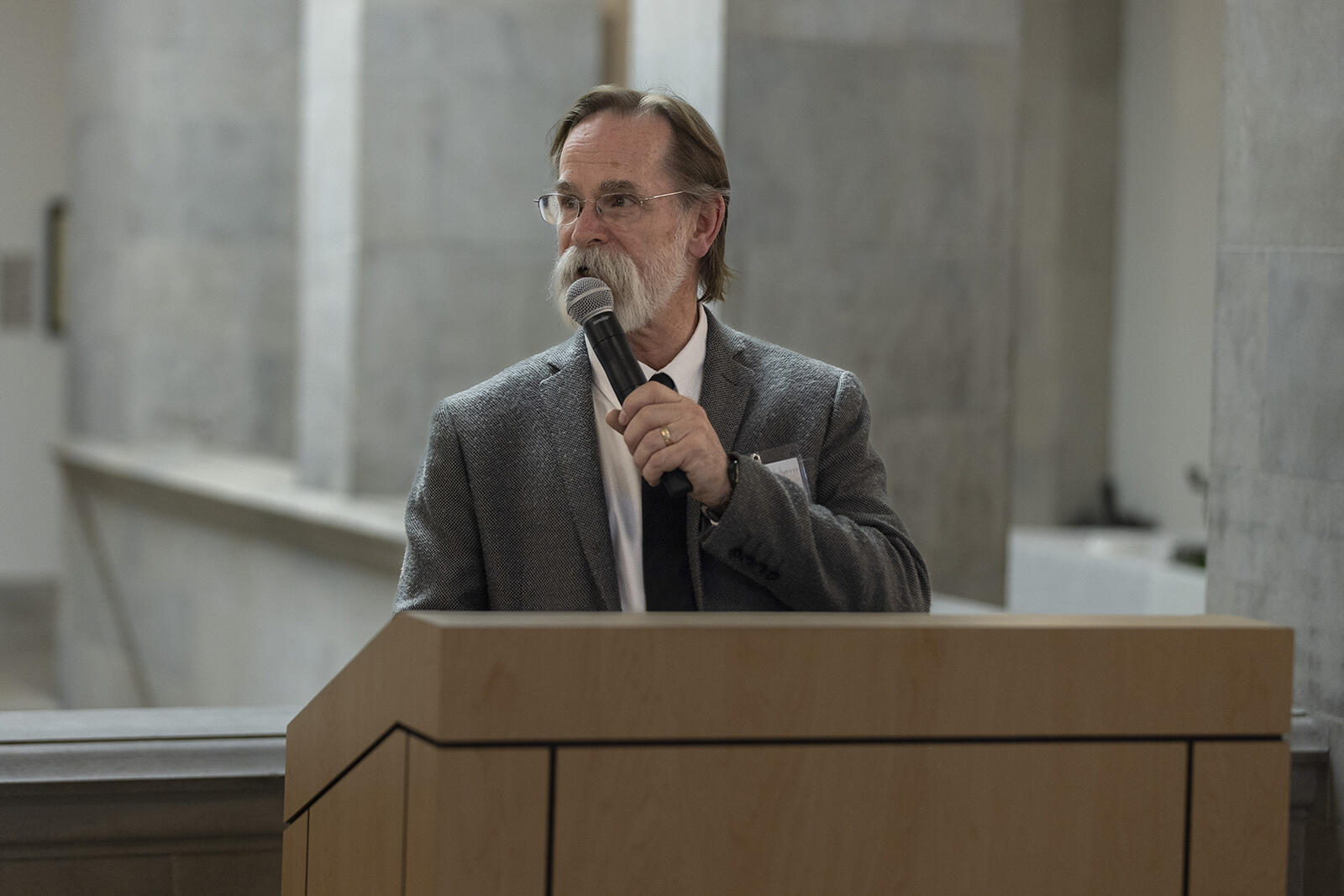 man speaking at podium